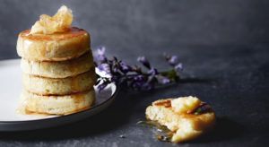 Homemade crumpets dripping with honey butter