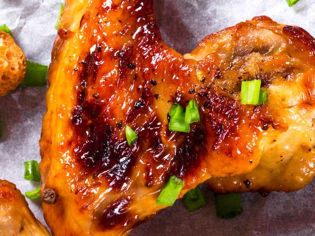 Sticky chicken wings glazed with honey and ginger, sprinkled with chopped spring onions. 