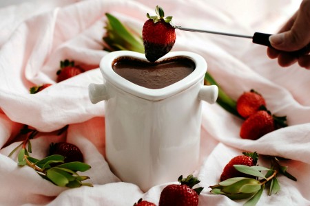 Vibrant strawberries dipped into creamy camel milk chocolate fondue